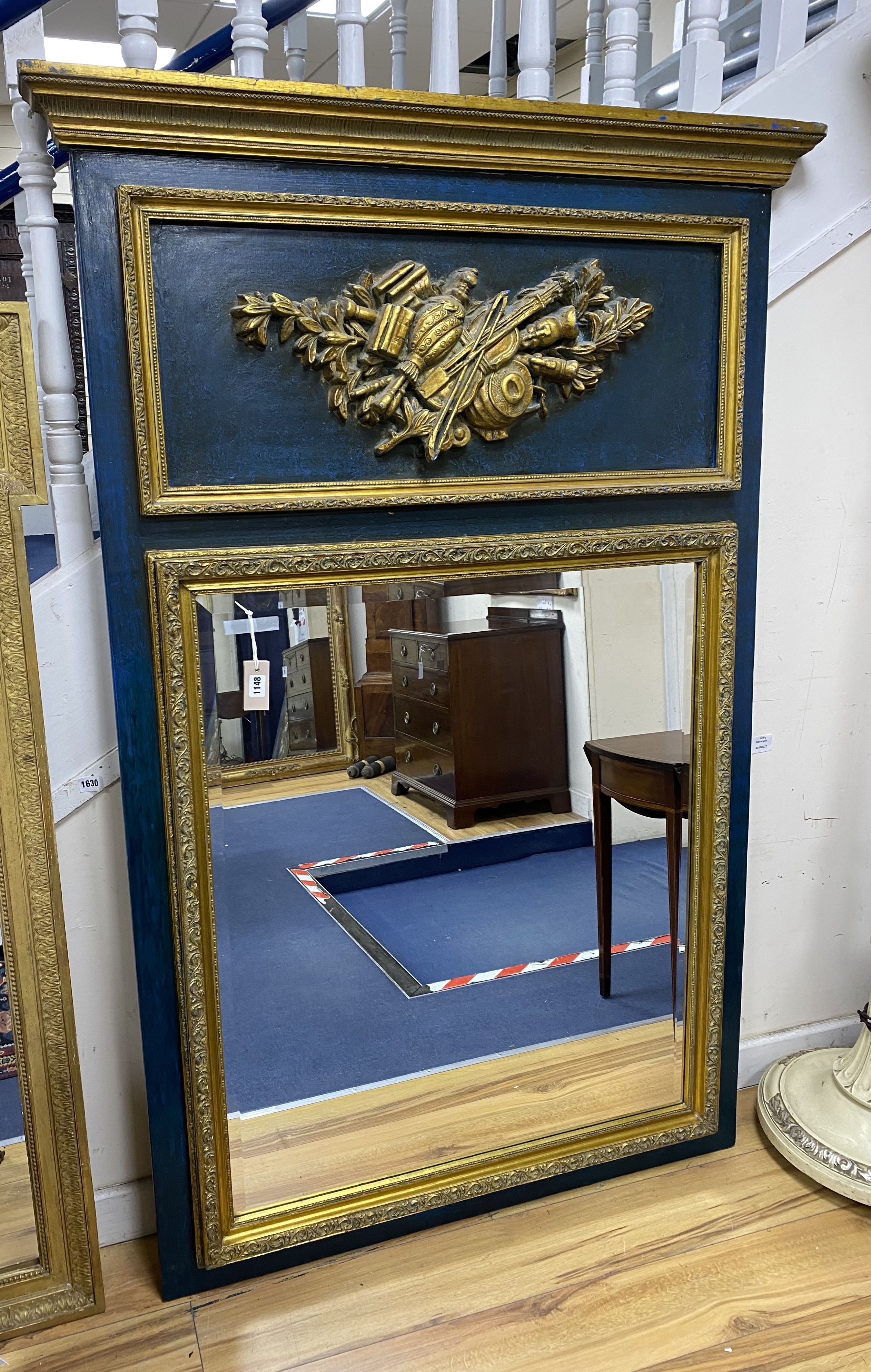 A 19th century French overmantel gilt and gesso mirror with musical themed emblem over on blue background, width 114cm, height 172cm